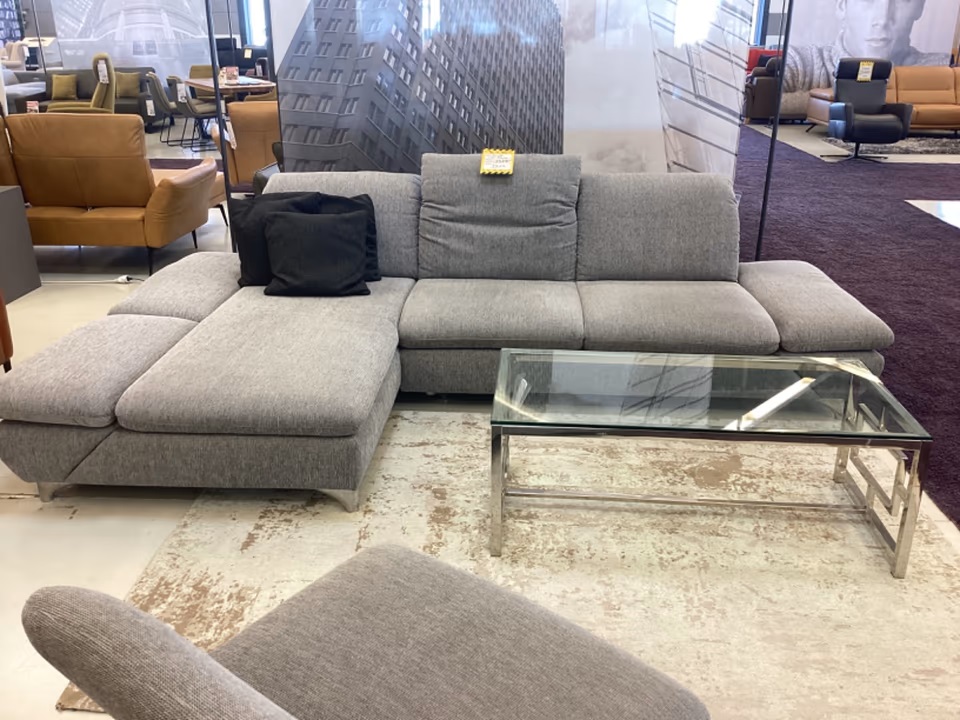 Ecksofa Viola Stoff grau und Hocker